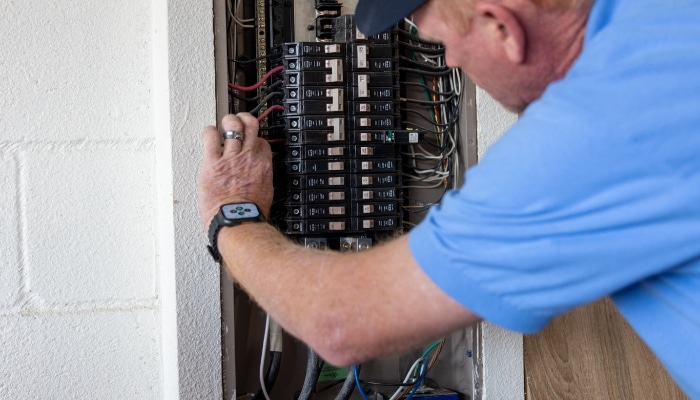 Techniaicn Looking At Electric Panel