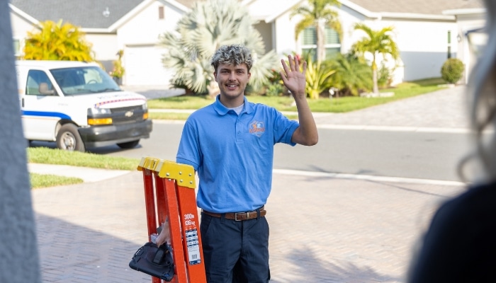 Technician Waving With Ladder